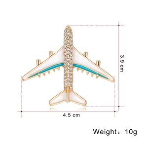 Golden airplane brooch with white enamel wings and sparkling rhinestones 4.5cm