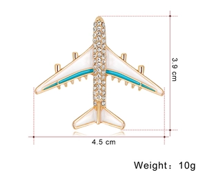 Detailed view of airplane brooch with rhinestones and dimensions 4.5 cm by 3.9 cm