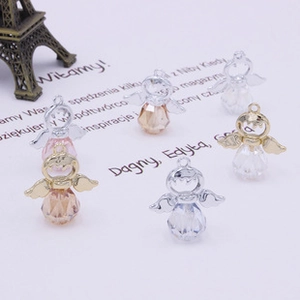 Detailed view of faceted angel charm pendants with metallic wings for DIY jewelry making