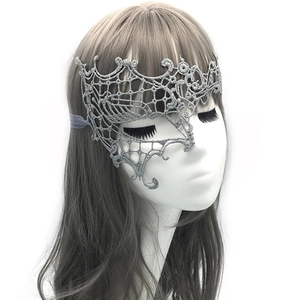 Detailed view of a silver lace phoenix masquerade mask worn on a female model