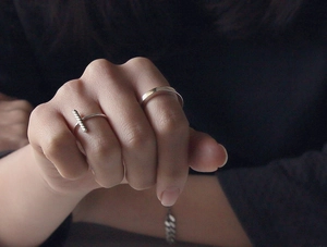 Detail of minimalist S925 sterling silver square line open rings set on a model hand