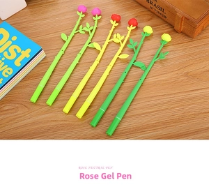 Detailed view of rose flower shaped gel pens with green stems on a wooden table