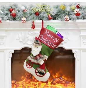 Detailed view of a festive Santa Claus riding a bike on a hanging Christmas stocking