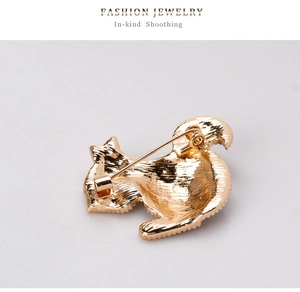 Detailed back view of a golden cat brooch showing metal texture and safety pin clasp