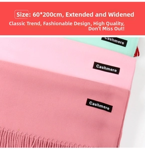 Detail of soft cashmere scarves in pink and green tones showing the 200x60cm dimensions