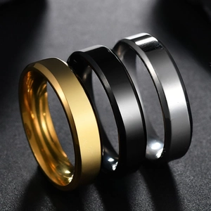 Macro shot of 6mm polished stainless steel flat rings in gold, black, and silver finish