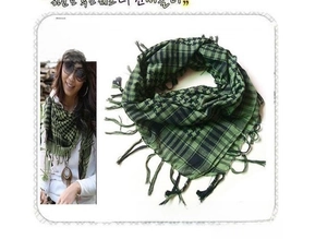 Detailed view of khaki and black checkered shemagh scarf with fringe and soft cotton texture