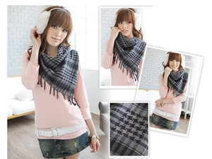 Detail of houndstooth plaid tactical scarf with tassel fringe for outdoor warmth