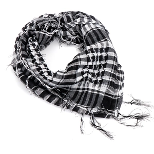Detail of checkered tactical scarf featuring woven patterns and fringed tassel edges