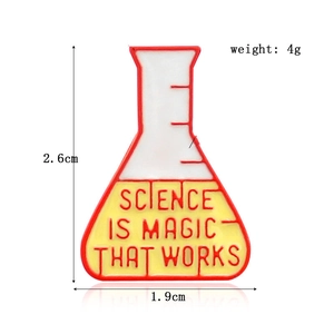 Detailed shot of science flask enamel pin with Science Is Magic That Works text