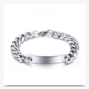 Macro view of a polished stainless steel Cuban link bracelet with a blank ID plate