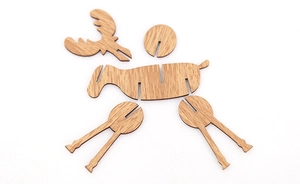 Flat lay of disassembled wooden reindeer puzzle pieces showing natural wood grain texture