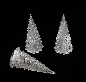 Close-up of three clear crystal Christmas tree ornaments with detailed leaf textures