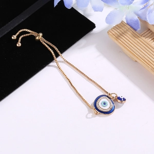 Elegant gold evil eye bracelet with sparkling crystals and adjustable sliding chain clasp