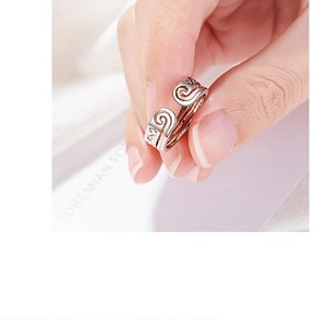 Detailed shot of double-layered silver and rose gold open ring with inner engraving
