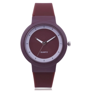 Close-up of a burgundy silicone quartz watch featuring a dual-tone minimalist dial