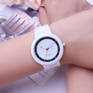 Close-up of minimalist white silicone quartz watch with a bicolored dial on a model wrist