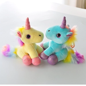 Colorful plush unicorn toys in blue and yellow with rainbow hair and glitter horns