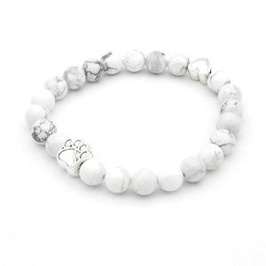 Detailed close-up of white marble beaded bracelet with silver paw and heart charms
