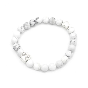 Detailed view of white marble beads bracelet featuring silver heart and paw print charms