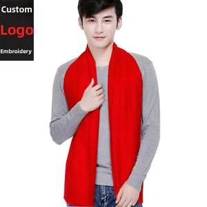 Close-up of a classic red men's winter scarf showing smooth texture on male model
