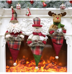 Close-up of three festive knitted Christmas stockings with Santa, snowman and reindeer figures