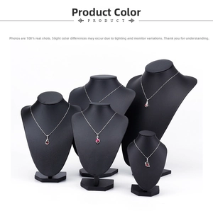 Detail view of various ruby pendant designs displayed on black neck busts