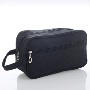 Detail of black canvas toiletry bag with dual zipper compartments and side handle