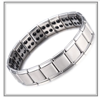 Detail of silver magnetic therapy bracelet with black health stones on inner band