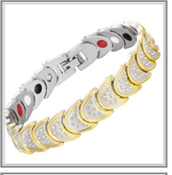 Detail view of gold and silver plated magnetic therapy bracelet with inset clear crystals