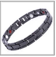 Detail view of black plated copper magnetic health bracelet with red and silver inserts