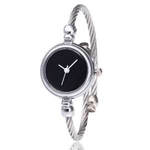 Macro shot of silver cable-twist bangle watch with a minimalist black dial and steel hands