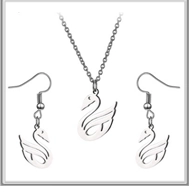 Detailed view of silver swan necklace and earrings set with hollowed geometric design