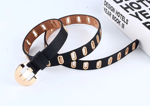 Close-up of black PU leather belt with gold round buckle and decorative metal eyelets