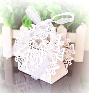 Detailed laser-cut butterfly gift box in white pearl paper with a silk ribbon bow