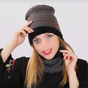 Close-up of gray knitted winter hat and neck warmer with thick faux fur lining texture