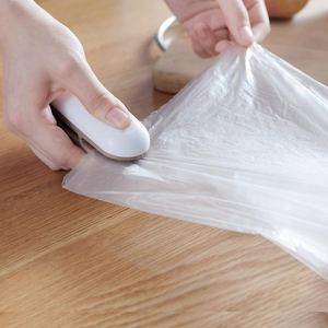 Portable mini heat sealer for food plastic bags, hand-held sealing machine in white and grey