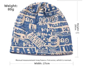 Macro shot of newspaper print beanie showing 28cm length and 27cm width measurements