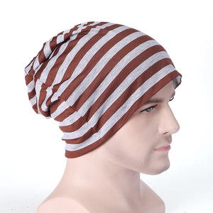 Close-up of soft brown and grey striped slouchy beanie with high elastic knit texture