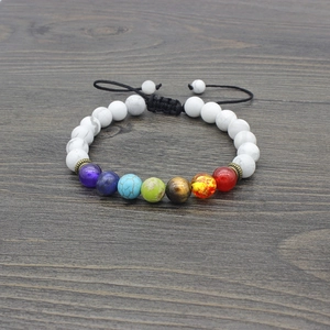 Macro detail of seven chakra energy beads with white turquoise and black braided cord