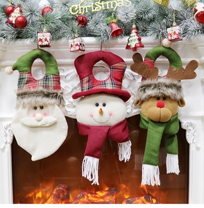 Close-up of Santa, Snowman and Reindeer plush door hangers for Christmas decor