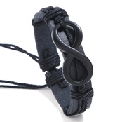 Close-up of black braided leather bracelet featuring a metallic infinity symbol charm