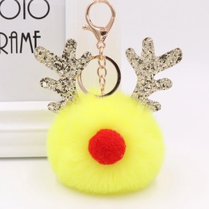 Close-up of yellow plush reindeer keychain with silver sequin antlers and golden ring