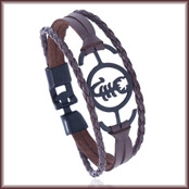Detail of multi-layer brown leather bracelet featuring a black metal Scorpio zodiac charm