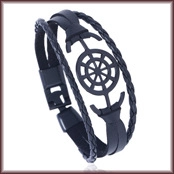 Close-up of black braided leather bracelet with metal anchor and ship wheel charms