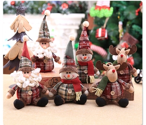 Detail of Christmas plush figurines showing plaid fabric textures and festive scarf details