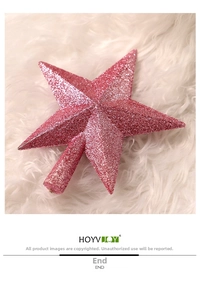 Pink glitter Christmas tree topper star on white faux fur background decoration