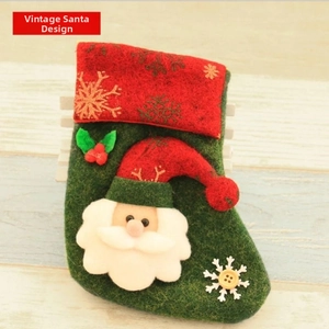 Detail of vintage Santa Claus felt Christmas stocking with berry and snowflake accents