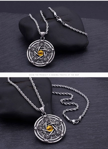 Macro detail of gothic angel pendant featuring a yellow eye inlay and pentagram design