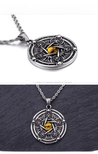 Detail of vintage star pendant necklace with amber stone and silver braided chain